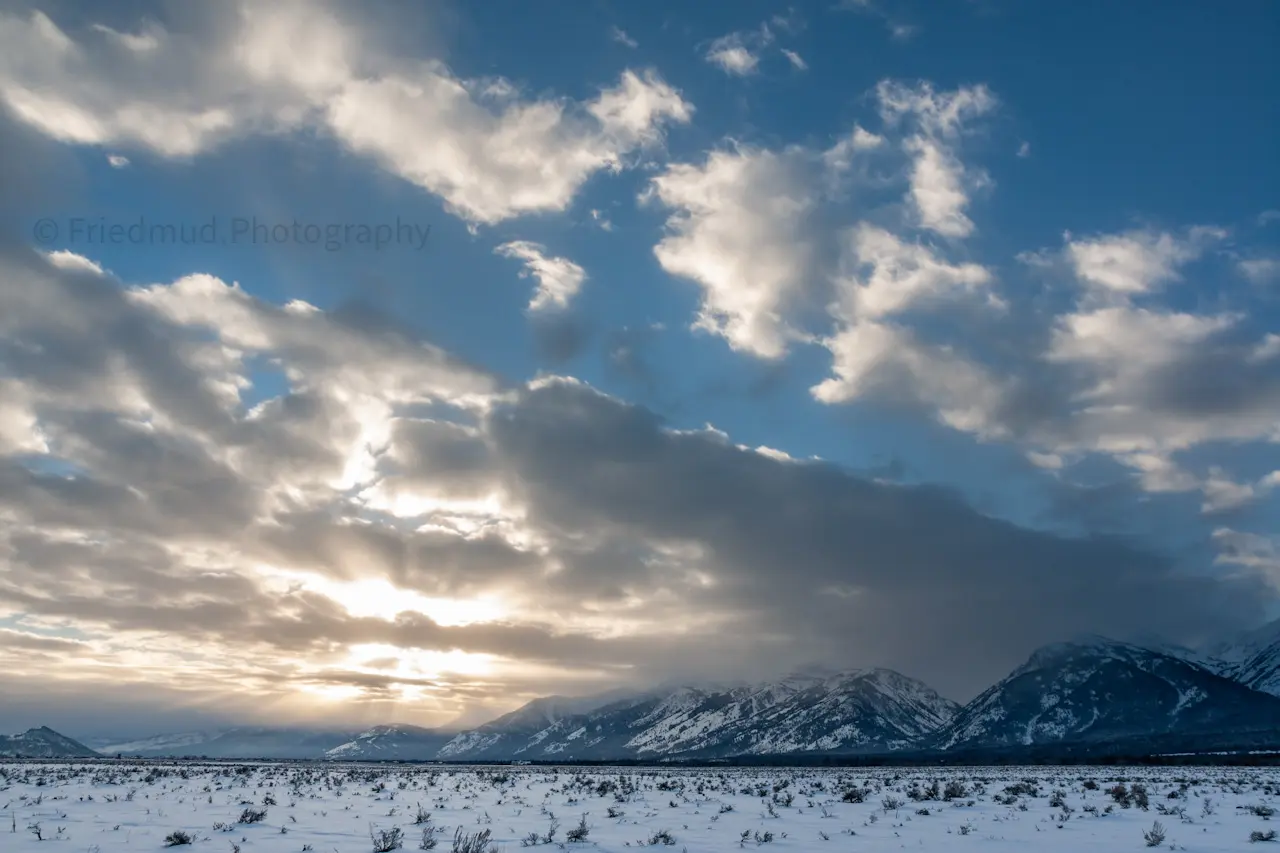 The%20setting%20sun%20breaks%20through%20the%20clouds%20above%20the%20Tetons%20in%20Teton%20National%20Park.