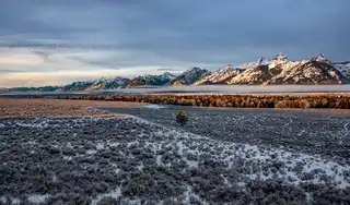 A%20fog%20lies%20low%20in%20front%20of%20the%20Teton%20Mountains%20in%20Grand%20Teton%20National%20Park.