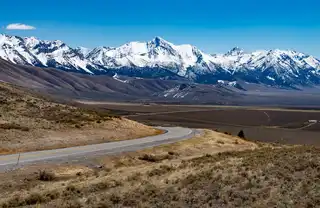 The%20road%20curves%20out%20of%20sight%20in%20the%20Sawtooth%20mountains%20in%20central%20Idaho.%20%20Shot%20just%20north%20of%20Mackay%20Idaho.