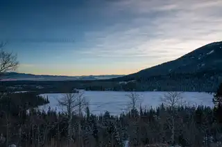 Frozen%20Taggart%20lake%20as%20the%20sun%20sets%20behind%20the%20Tetons%20in%20Teton%20National%20Park.